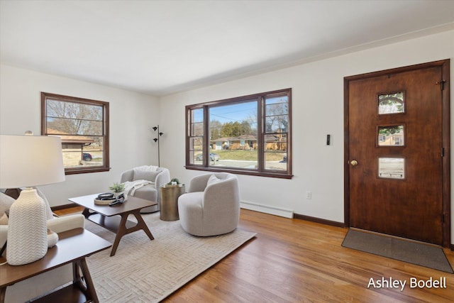 living room featuring plenty of natural light, wood finished floors, and baseboards