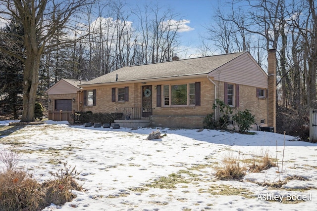 ranch-style house with a chimney and brick siding