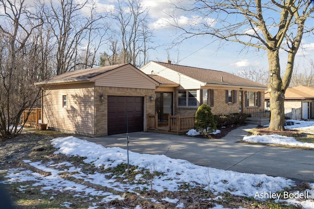 single story home featuring an attached garage, concrete driveway, and brick siding