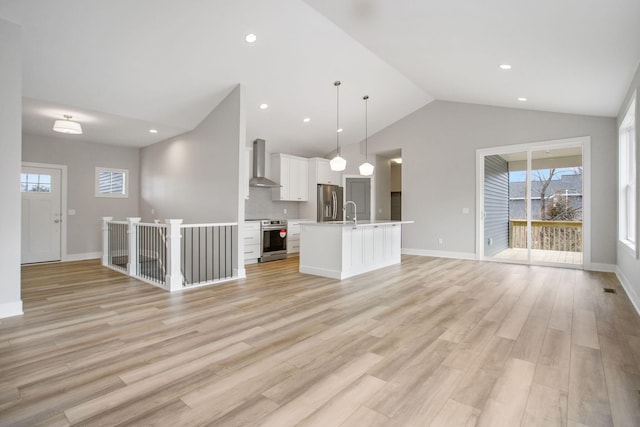 unfurnished living room with vaulted ceiling, recessed lighting, baseboards, and light wood-style floors