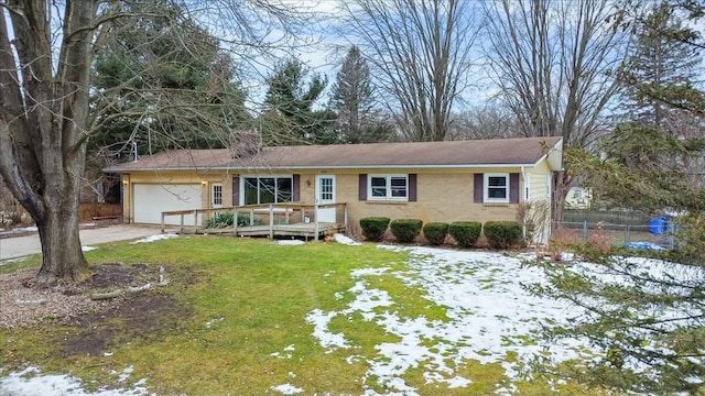 single story home featuring brick siding, a yard, concrete driveway, fence, and a garage