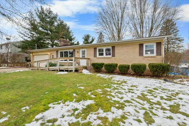 single story home with a chimney, a lawn, and a wooden deck