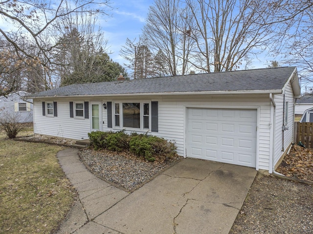 ranch-style house featuring a garage, a shingled roof, fence, and concrete driveway