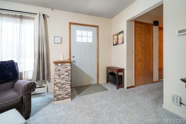 carpeted foyer entrance featuring baseboard heating