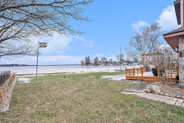 view of yard with a deck with water view