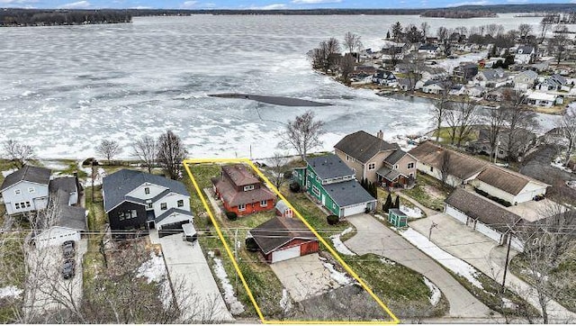 birds eye view of property with a water view and a residential view