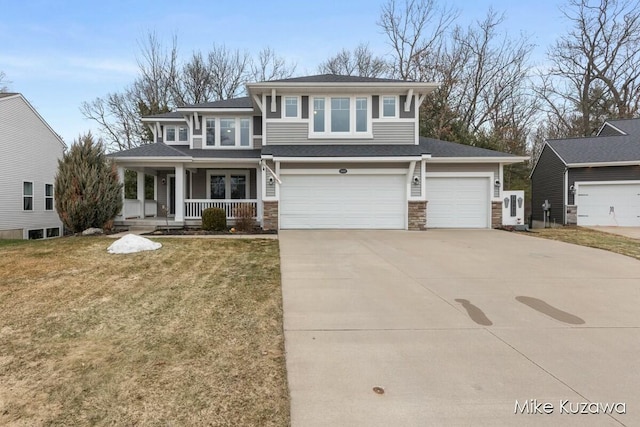 prairie-style home featuring an attached garage, concrete driveway, a porch, and a front yard