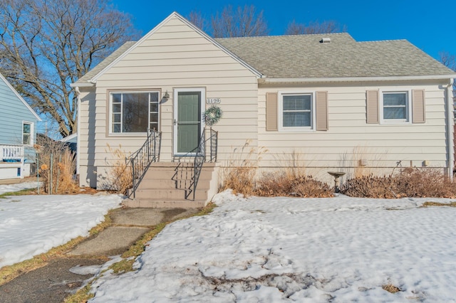 view of front of home with a shingled roof