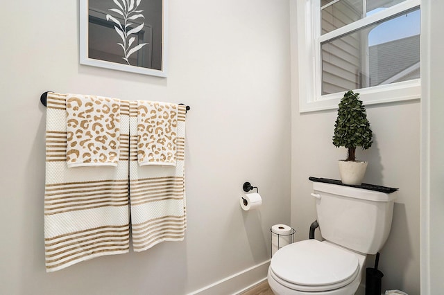 bathroom with toilet and baseboards