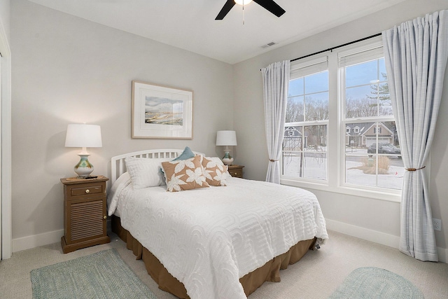 bedroom featuring light carpet, visible vents, and baseboards