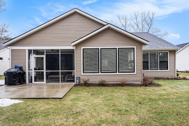 back of property featuring a lawn, a patio area, and a sunroom