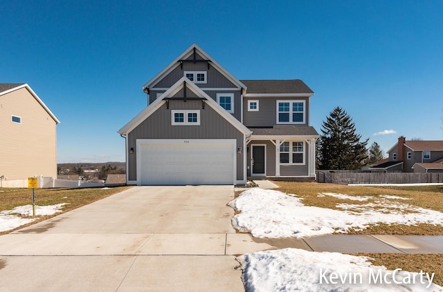 view of front of house with concrete driveway, board and batten siding, an attached garage, and fence