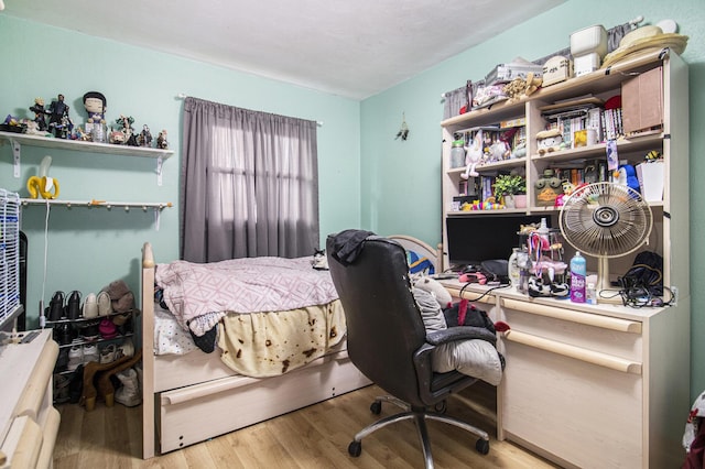 bedroom featuring wood finished floors