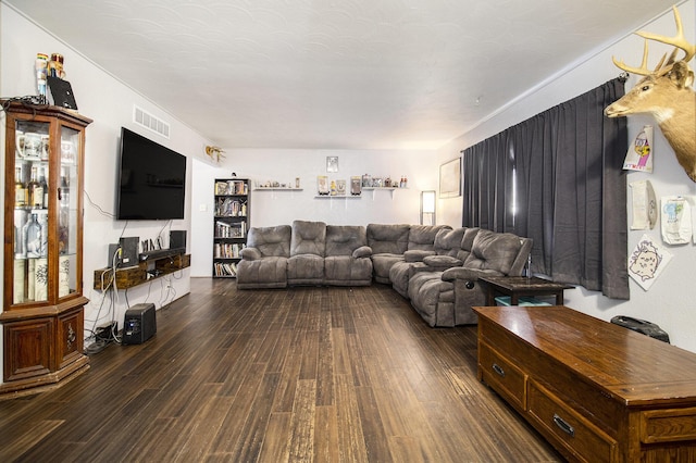 living area featuring dark wood-style floors and visible vents