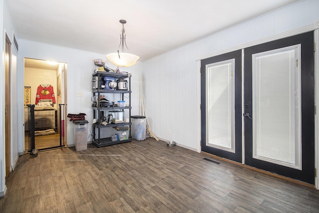 dining room featuring french doors, wood finished floors, and visible vents