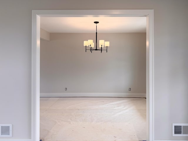 10712 Melanie Dr, Allendale, MI 49401 - empty room with visible vents, baseboards, and a notable chandelier
