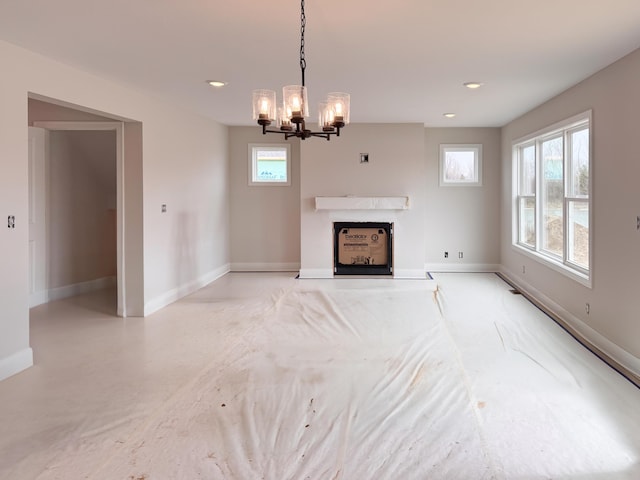 10712 Melanie Dr, Allendale, MI 49401 - unfurnished living room with an inviting chandelier, recessed lighting, a healthy amount of sunlight, and a fireplace