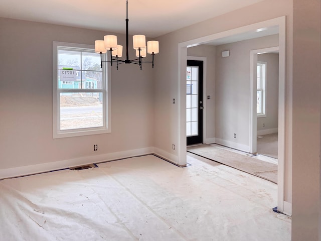 10712 Melanie Dr, Allendale, MI 49401 - unfurnished room with an inviting chandelier, baseboards, and visible vents
