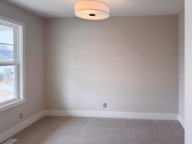 10712 Melanie Dr, Allendale, MI 49401 - carpeted empty room featuring baseboards, visible vents, and a healthy amount of sunlight