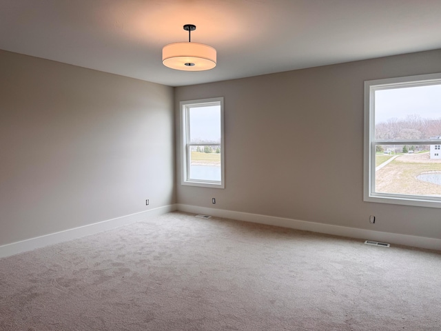 10712 Melanie Dr, Allendale, MI 49401 - carpeted empty room featuring baseboards and visible vents