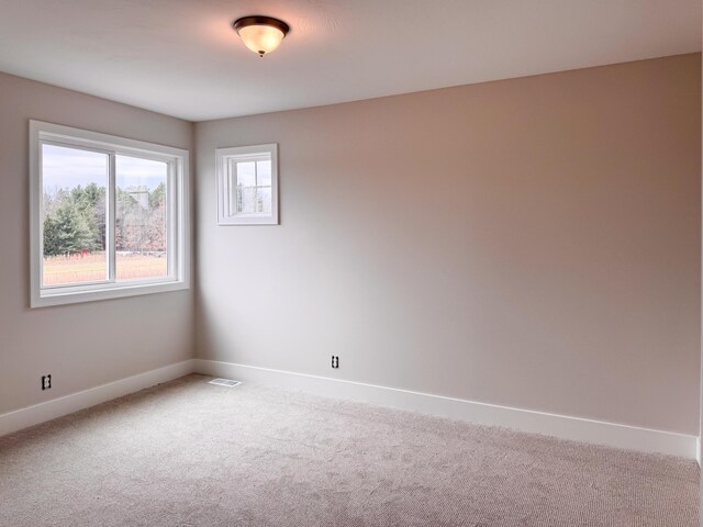 10712 Melanie Dr, Allendale, MI 49401 - unfurnished room featuring carpet floors, baseboards, and visible vents
