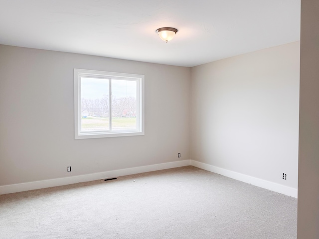 10712 Melanie Dr, Allendale, MI 49401 - spare room with baseboards, visible vents, and light carpet