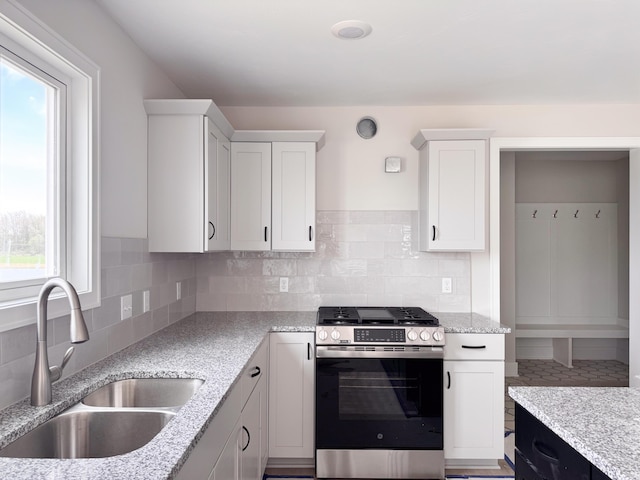 10712 Melanie Dr, Allendale, MI 49401 - kitchen featuring a sink, white cabinetry, backsplash, and stainless steel gas range oven