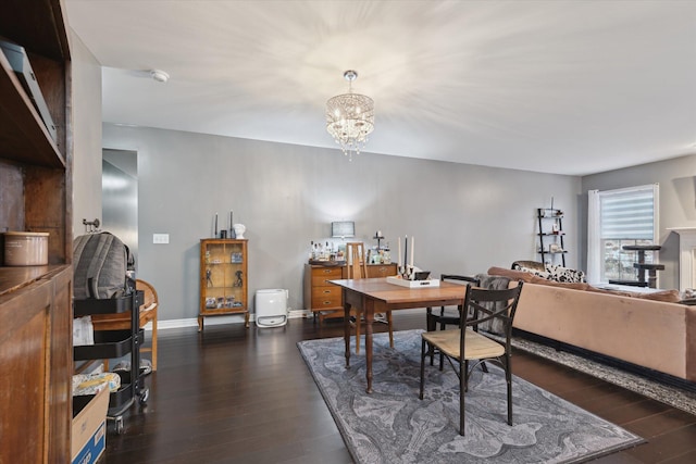 dining area with baseboards, a chandelier, and dark wood-type flooring