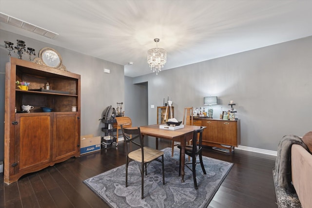 dining room with a chandelier, visible vents, dark wood finished floors, and baseboards