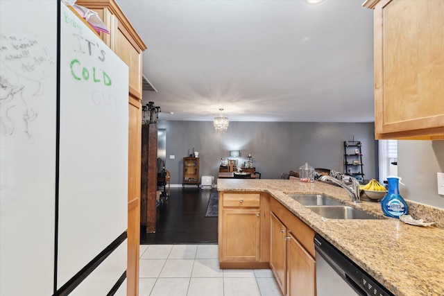 kitchen featuring light tile patterned floors, light stone counters, a peninsula, a sink, and stainless steel dishwasher