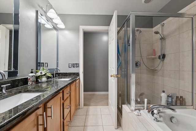 bathroom with double vanity, tile patterned floors, a sink, and a shower stall