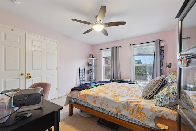 bedroom featuring carpet floors, baseboards, and a ceiling fan