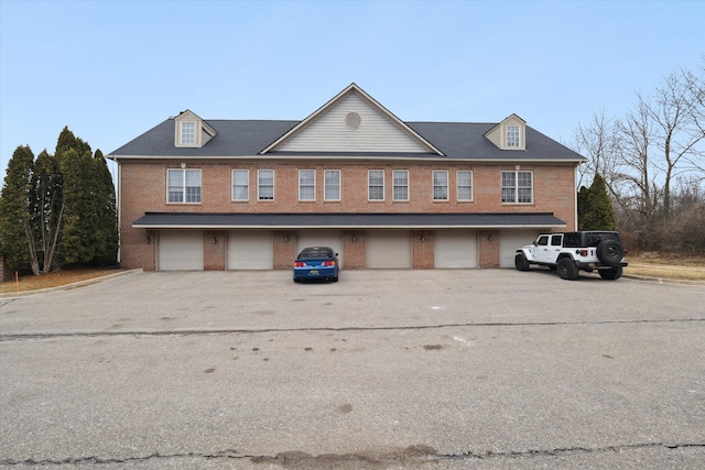 view of front facade with a garage and brick siding