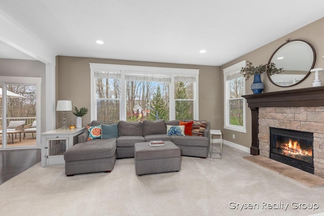 7313 Valhalla Dr, Hudsonville, MI 49426 - carpeted living room featuring recessed lighting, a stone fireplace, and baseboards
