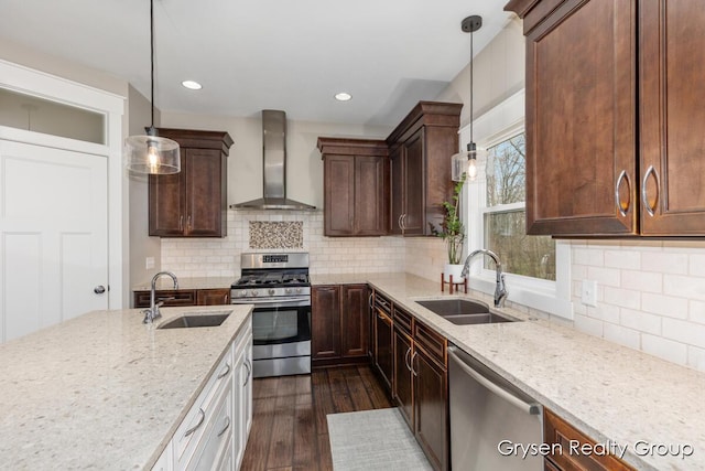 7313 Valhalla Dr, Hudsonville, MI 49426 - kitchen featuring a sink, stainless steel appliances, light stone countertops, and wall chimney exhaust hood