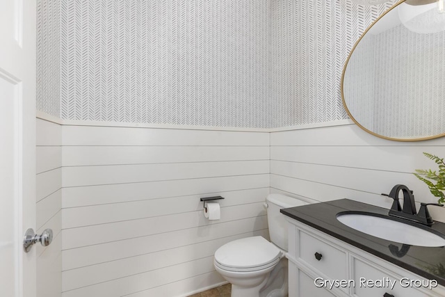 7313 Valhalla Dr, Hudsonville, MI 49426 - half bathroom with wallpapered walls, a wainscoted wall, toilet, and vanity
