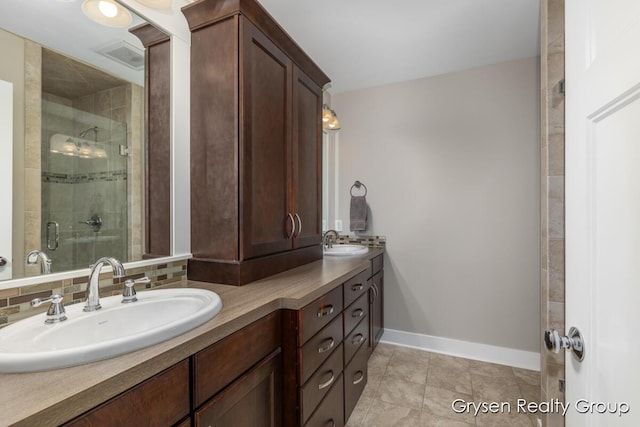7313 Valhalla Dr, Hudsonville, MI 49426 - full bathroom featuring double vanity, a shower stall, baseboards, and a sink
