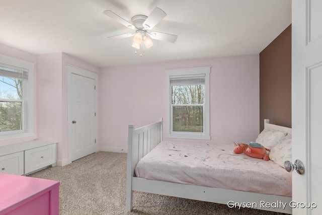 7313 Valhalla Dr, Hudsonville, MI 49426 - bedroom featuring multiple windows, ceiling fan, carpet floors, and baseboards