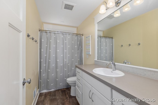 7313 Valhalla Dr, Hudsonville, MI 49426 - full bathroom with wood finished floors, visible vents, toilet, and vanity