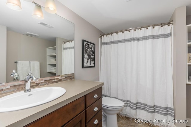 7313 Valhalla Dr, Hudsonville, MI 49426 - bathroom featuring visible vents, toilet, vanity, and decorative backsplash
