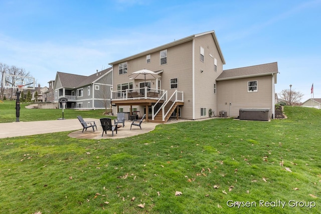 7313 Valhalla Dr, Hudsonville, MI 49426 - rear view of house featuring a fire pit, a patio, a wooden deck, a hot tub, and a lawn