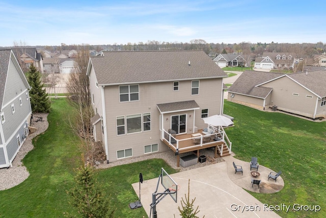 7313 Valhalla Dr, Hudsonville, MI 49426 - back of house featuring a lawn, a wooden deck, a patio, and a residential view