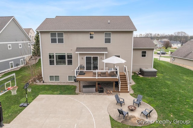 7313 Valhalla Dr, Hudsonville, MI 49426 - back of house with a patio area, a lawn, a hot tub, a deck, and a fire pit