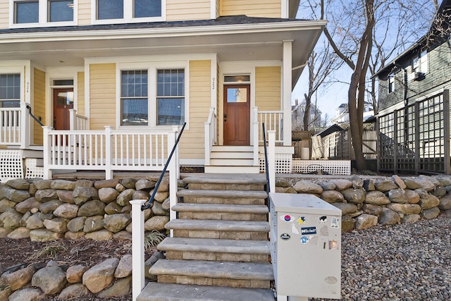 view of exterior entry with covered porch