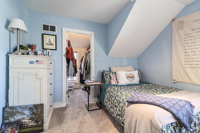 bedroom with lofted ceiling, carpet flooring, visible vents, and baseboards