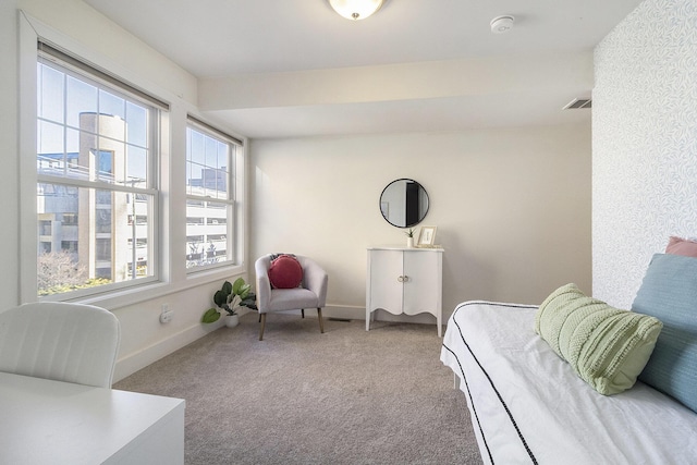 living area featuring carpet, visible vents, and baseboards