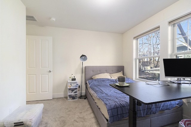 bedroom with carpet, visible vents, and baseboards