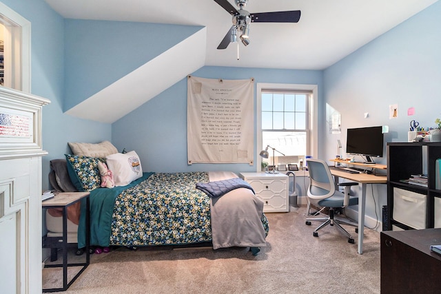 carpeted bedroom with vaulted ceiling and a ceiling fan