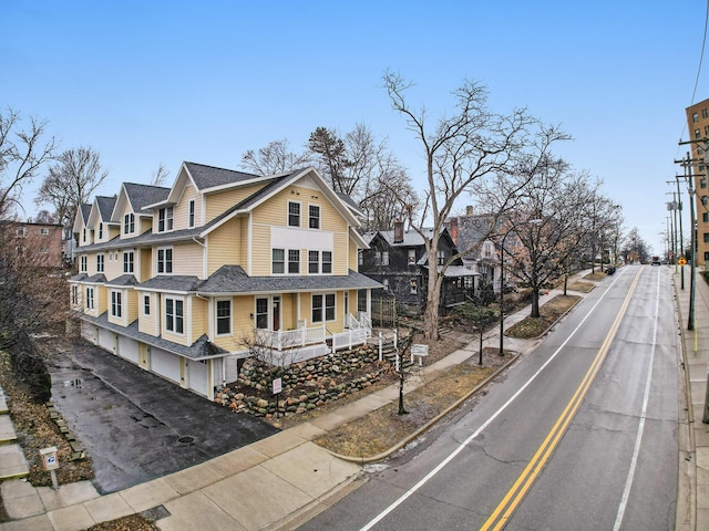 exterior space with a residential view, curbs, and sidewalks