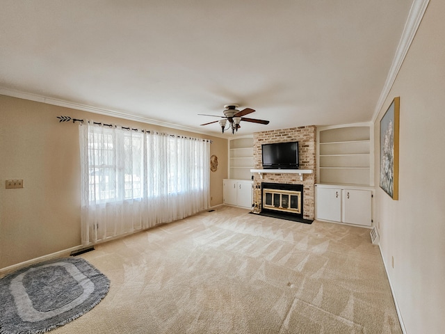 unfurnished living room featuring light carpet, baseboards, built in features, crown molding, and a brick fireplace